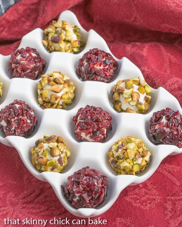 Festive Blue Cheese Balls in a white ceramic dish on a red napkin.