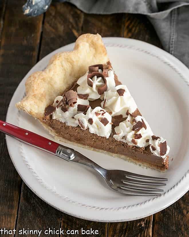 Overhead view of a slice of French Silk Pie on a white dessert plate with a red handled fork