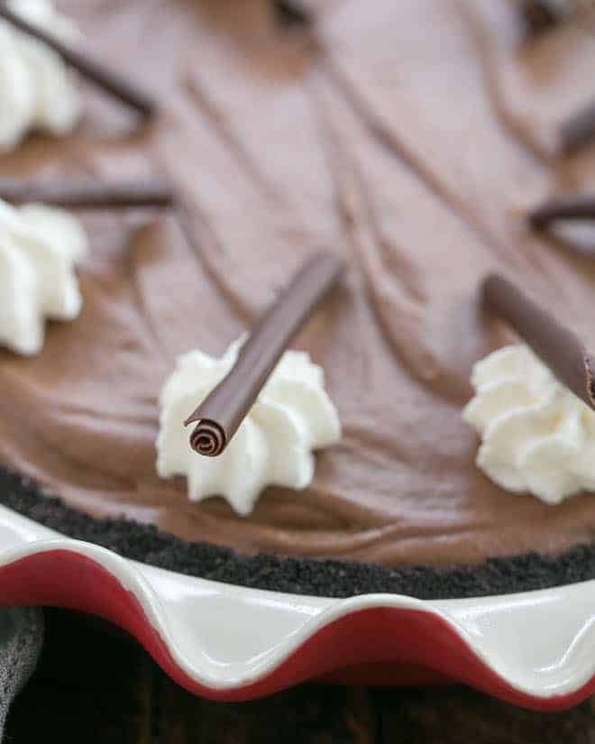 Close up of Frangelico French Silk Pie garnishes of whipped cream and chocolate curls.