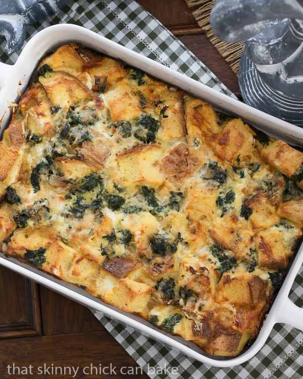 Gruyere Spinach Strata in a white casserole dish.