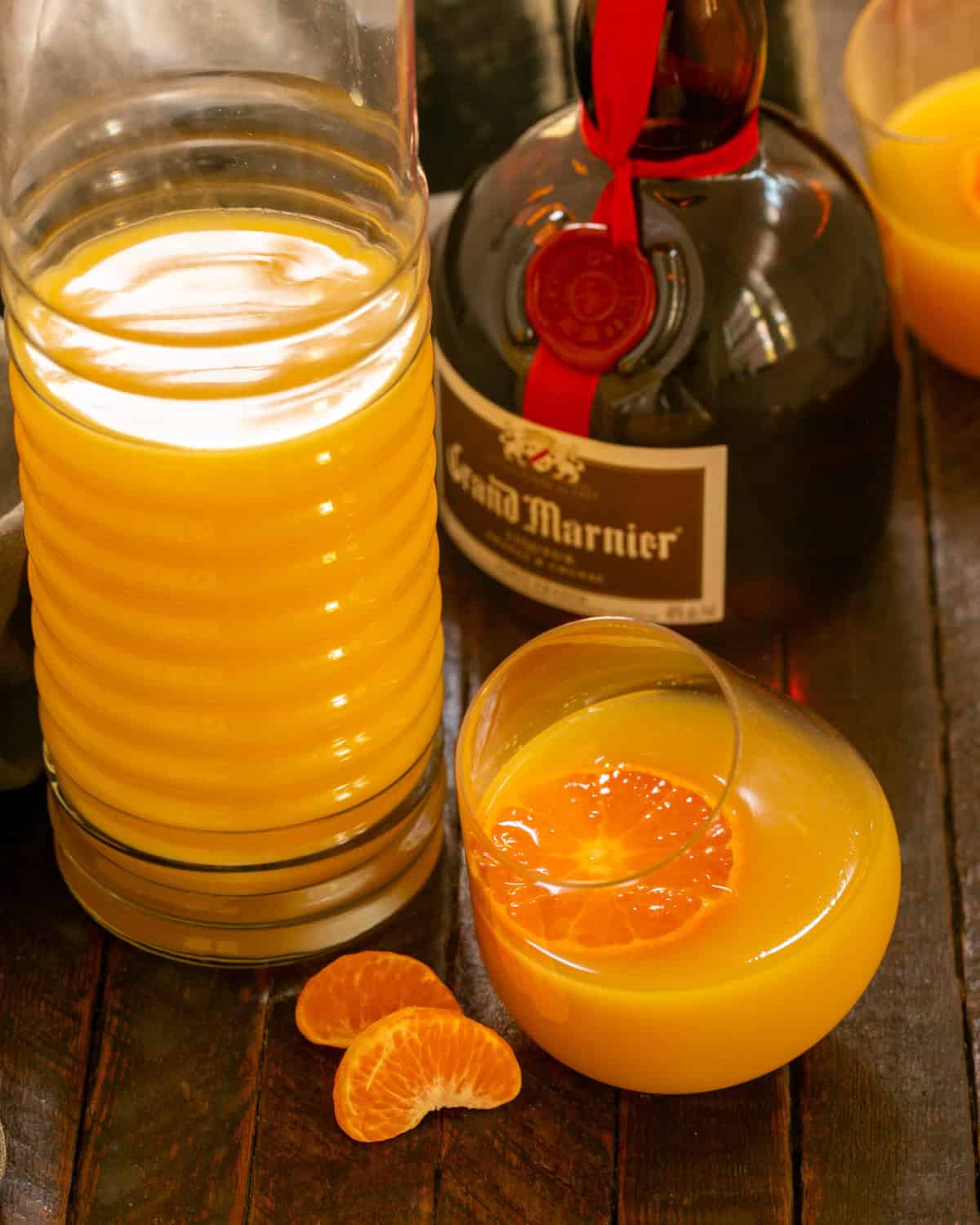 Grand Mimosa in a Viski glass next to a bottle of Grand Marnier.