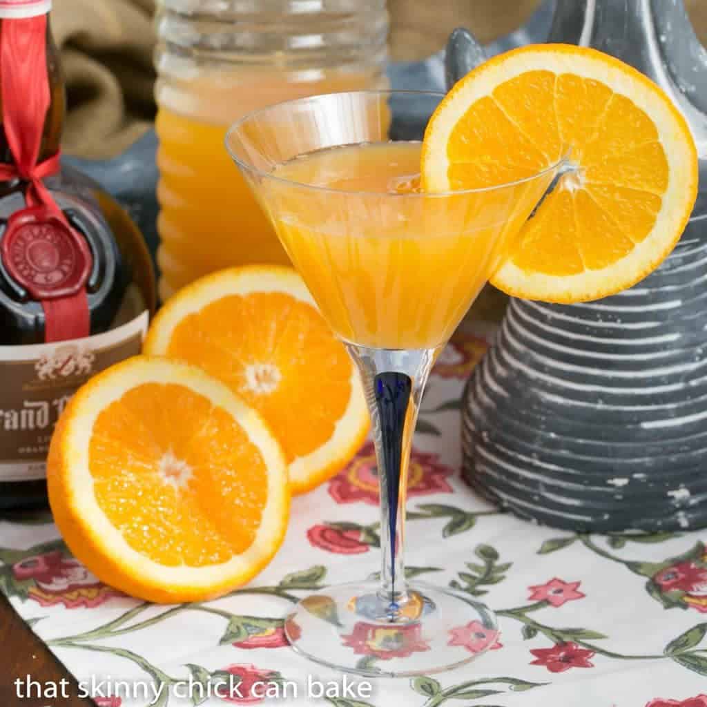 Grand Marnier Mimosa in a martini glass garnished with a slice of orange on the rim.