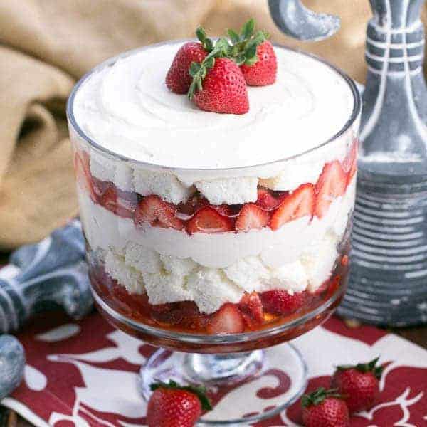 Strawberry Cheesecake Trifle | Layers of angel food cake, boozy berries and cream cheese filling