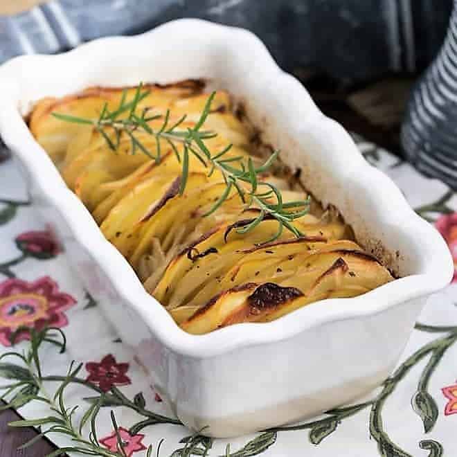 Hasseback potato casserole in a white ceramic loaf pan