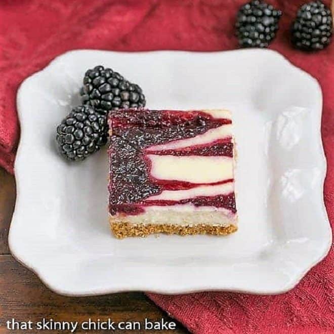 Blackberry Cheesecake Bar on a square white plate