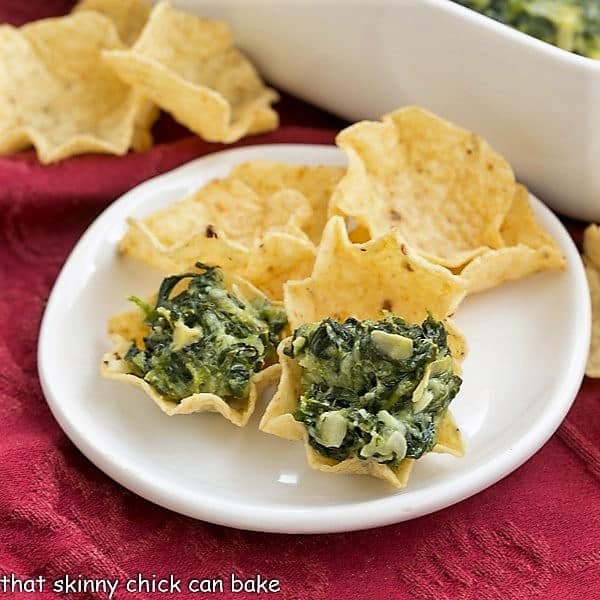 Cheesy Spinach Dip is one of the best dip recipes for any occasion! It's a warm dip, loaded with spinach, artichoke hearts, and cheese. Do you always head straight to the spinach artichoke dip when you see it at a party? Here's the best spinach dip recipe! Cheesy Spinach Dip on tortilla chips
