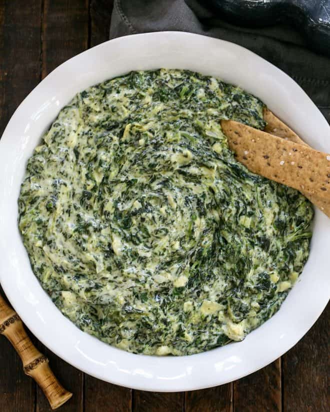Overhead view of a white casserole dish of warm Spinach Dip Recipe