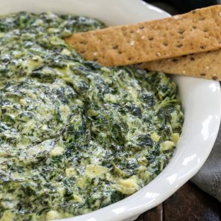 Baked Cheesy Spinach Dip in a white ceramic dish