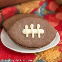 Chocolate Football Cookies | Chocolate cut-out cookies filled with buttercream and caramel!