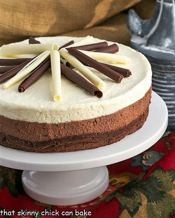 Layered Mousse Cake on a cake stand.