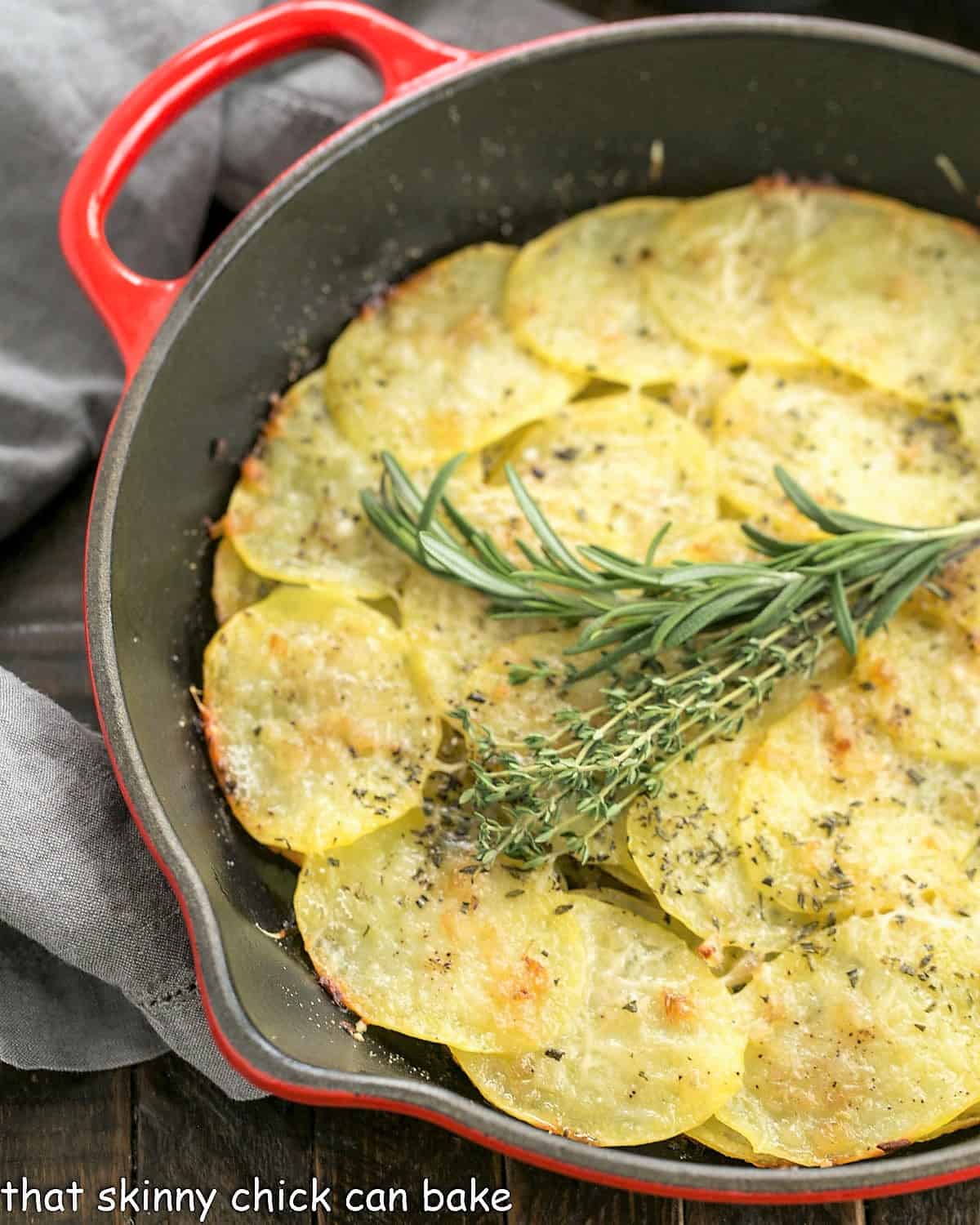 Overhead view of potato galette in a red cast iron skillet.