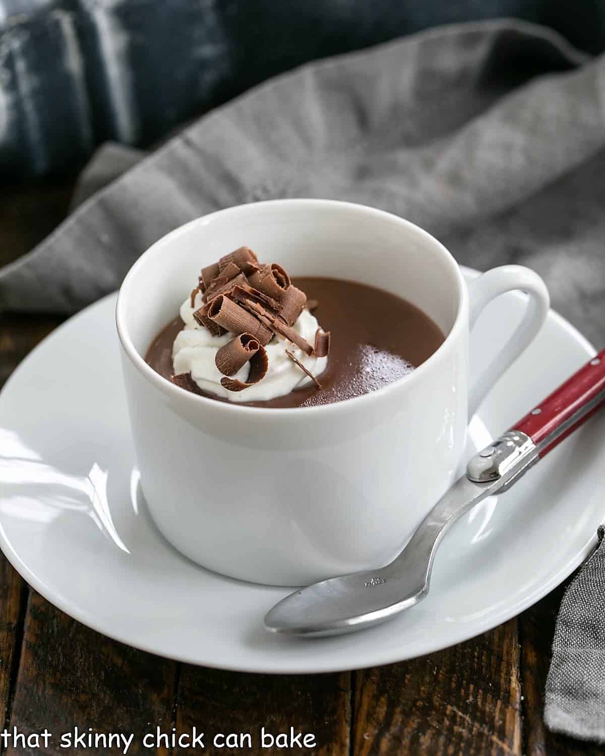 Cup of Italian hot chocolate topped with whipped cream and chocolate shavings.