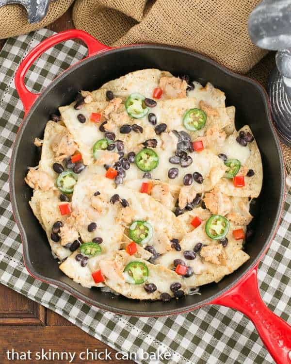 Overhead view of salmon nachos in a red skillet
