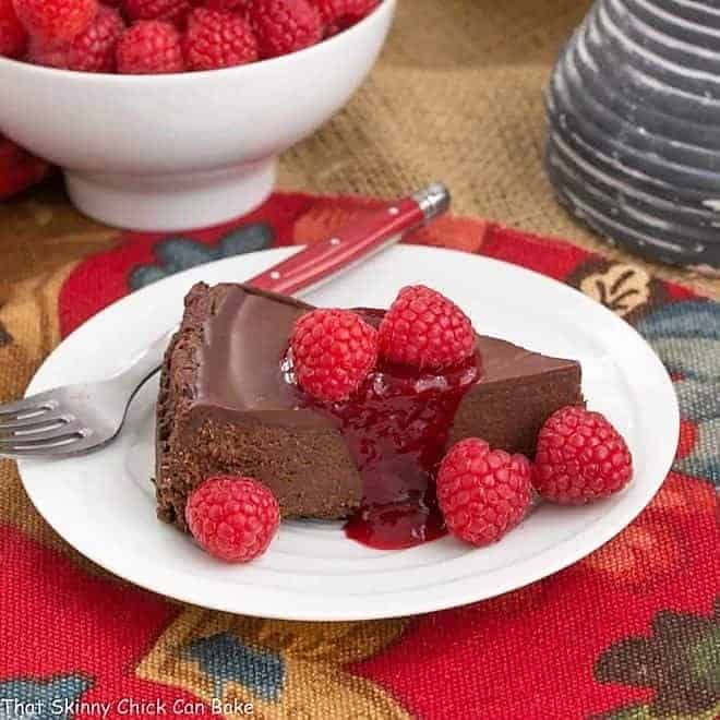 A slice of Chocolate Torte on a white dessert plate.