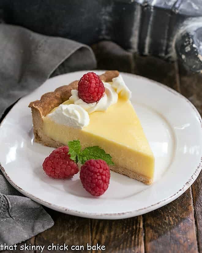 Slice of Creamy Lemon Tart on a white dessert plate