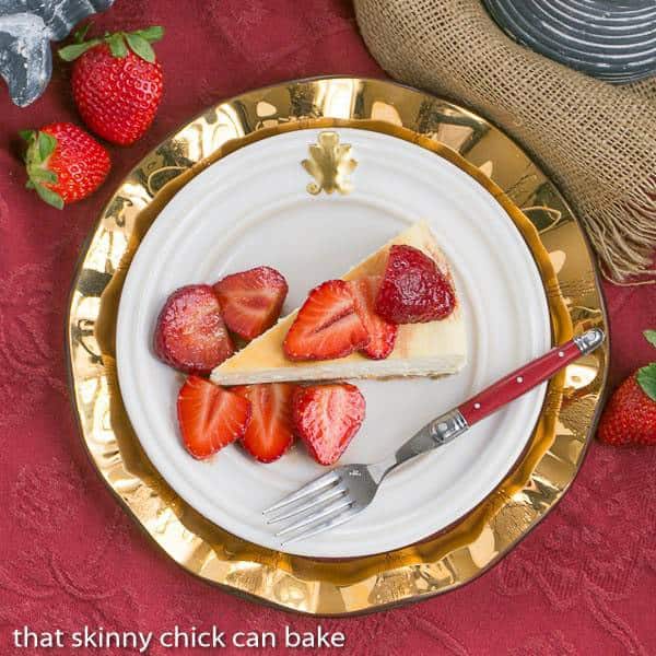 Mascarpone Cheesecake slice topped with berries on a white plate and gold charger