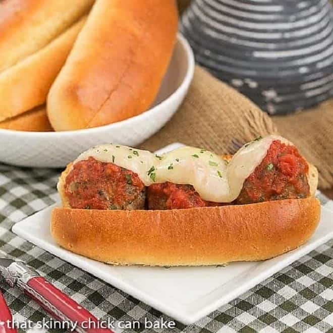 Easy Italian Meatball Subs on a white square plate on a checked napkin.