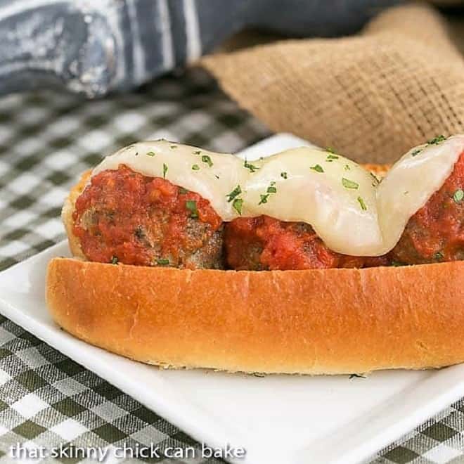 Meatball Sandwich on a white plate with gooey cheese topping.