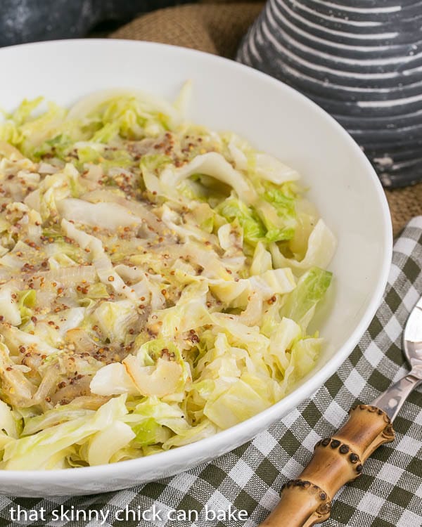 overhead image of a bowl full of chopped cabbage sauteed with mustard.