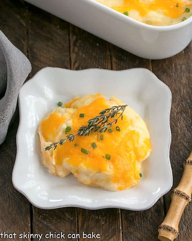 Overhead view o a serving of mashed potato casserole on a square white plate