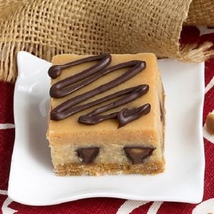 Peanut Butter Cheesecake Bars on a white square dessert plate