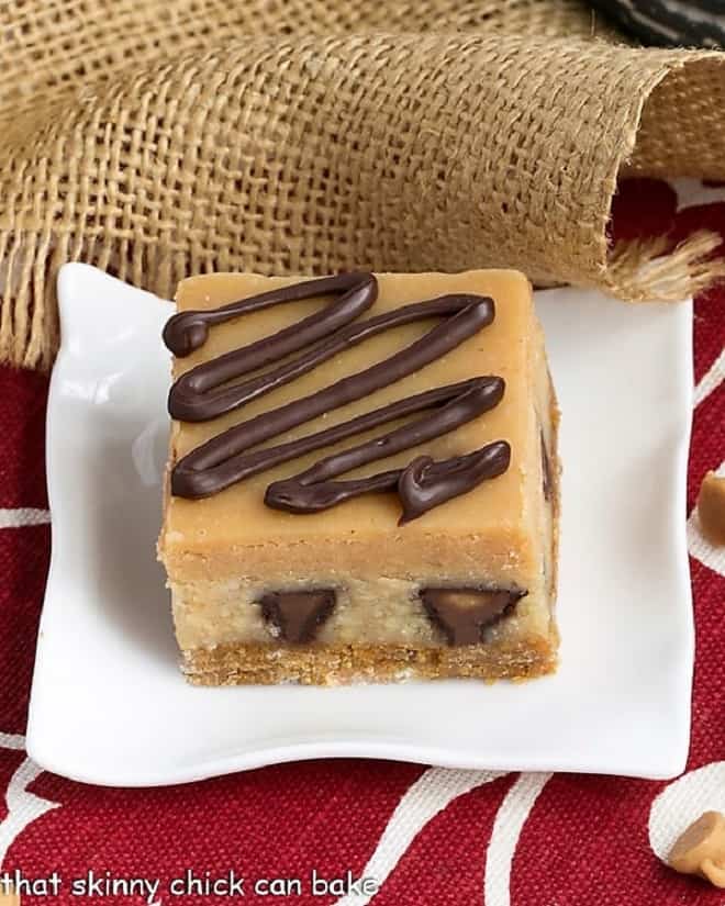 Peanut Butter Cheesecake Bars on a white square dessert plate