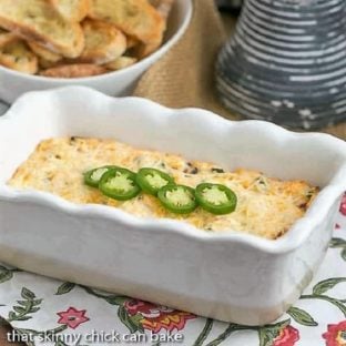 Jalapeno Popper Dip in a loaf pan topped with sliced jalapenos