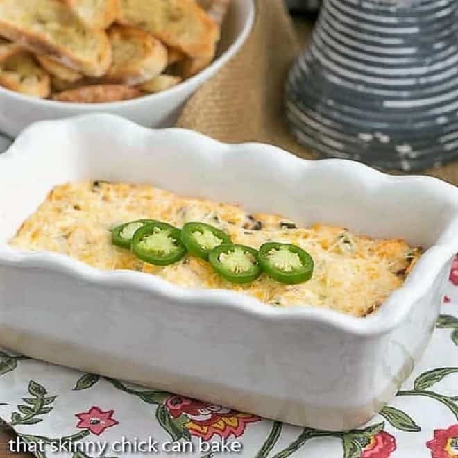 Jalapeno Popper Dip in a loaf pan topped with sliced jalapenos