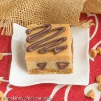 Peanut Butter Cheesecake Bars | Incredibly rich and filled with mini Reese's!