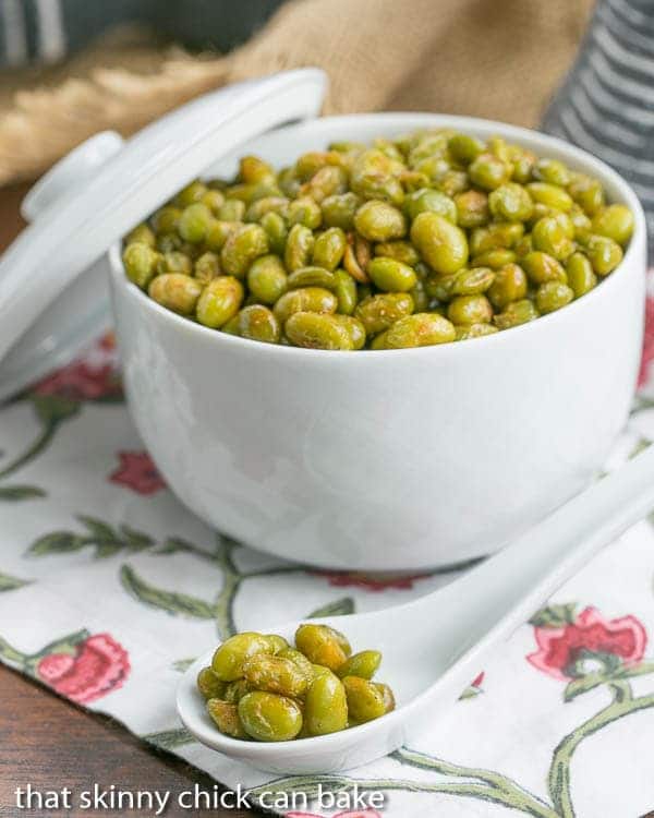 Roasted Creole Edamame in a white ceramic bowl with a spoonful in the foreground.