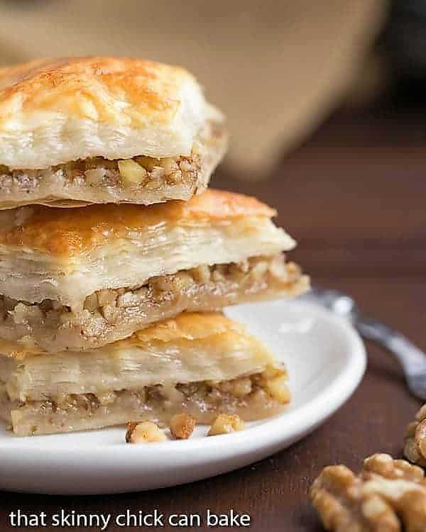 Diamonds of Baklava Recipe stacked on a small white plate.