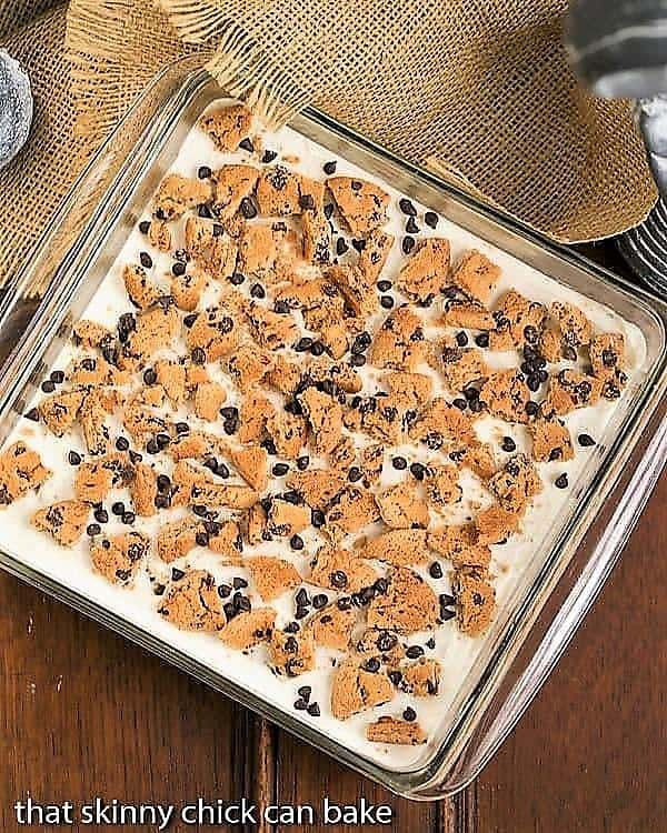 Overhead view of Milk & Cookies Lasagna in a square, glass pan.