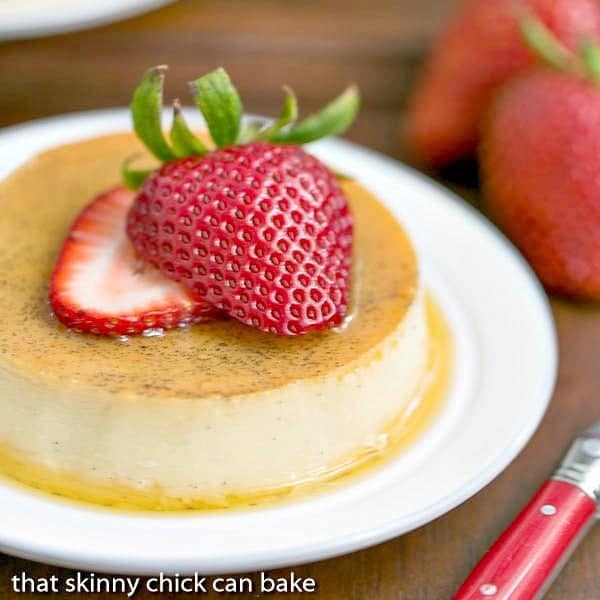 Mini Vanilla Flans topped with strawberry slices.