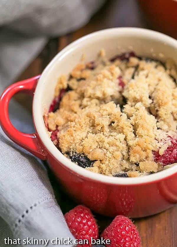 Overhead view of an Individual Berry Crisp in a red ceramic baking dish