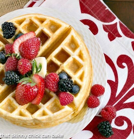 Homemade Buttermilk Waffles on a white plate with berries,