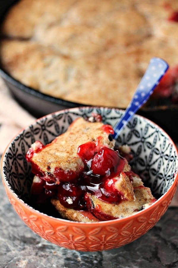 Cherry Cobbler in a red and blue patterned bowl with a blue polka dot spoon