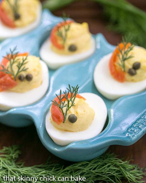 Smoked Salmon Deviled Eggs close up of garnished eggs in a blue ceramic egg dish