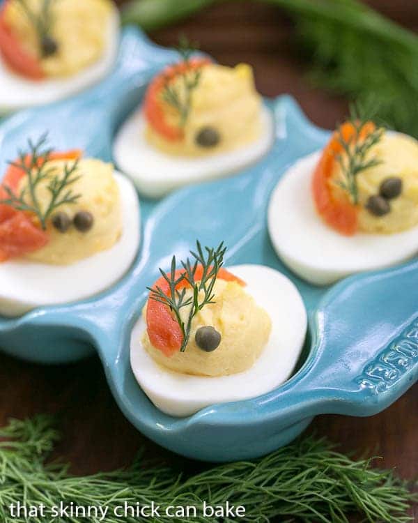 Smoked Salmon Deviled Eggs close up of garnished eggs in a blue ceramic egg dish.