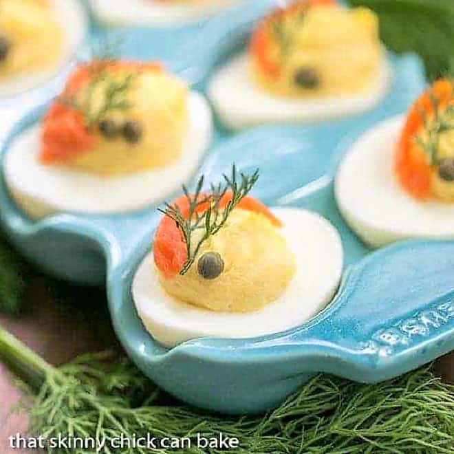 Smoked Salmon Deviled Eggs in a blue ceramic egg carton tray.