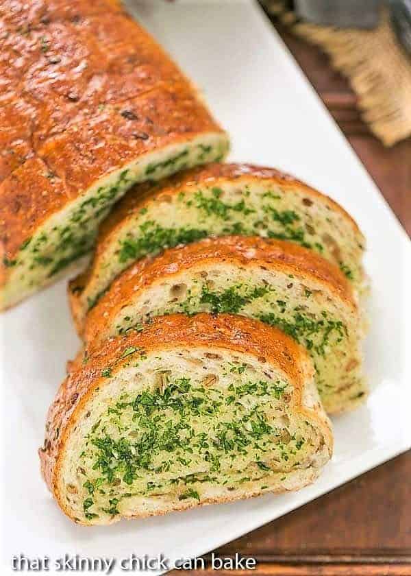  Overhead view of slices of Herb Garlic Bread on a white platter