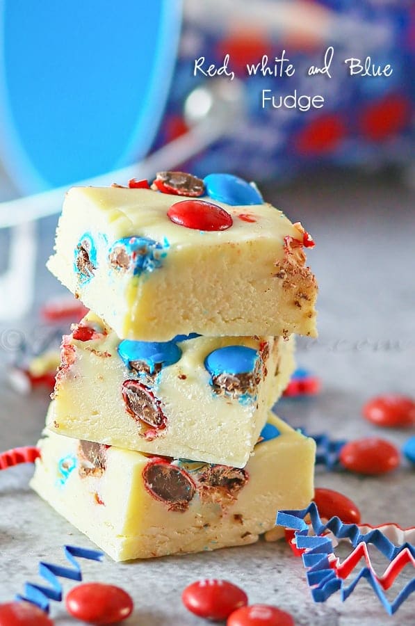 Red White and Blue Fudge stacked and surrounded by M&M's and confetti