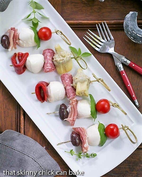 Antipasto Skewers on a rectangular white tray.