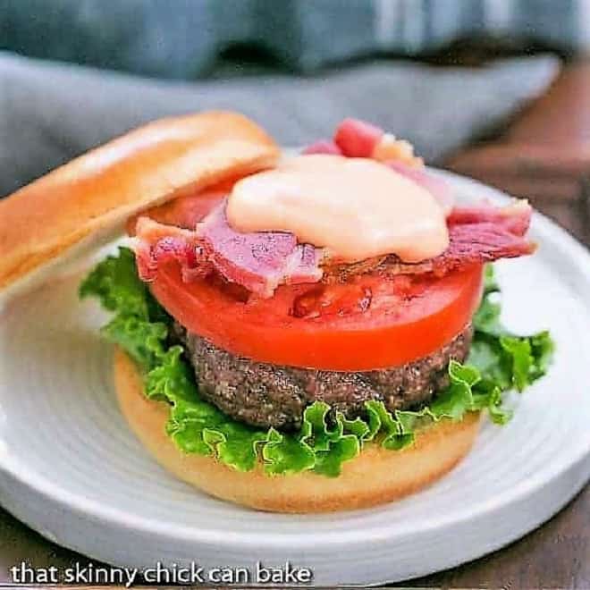 BLT Burge with Spicy Mayonnaise on a round white plate.