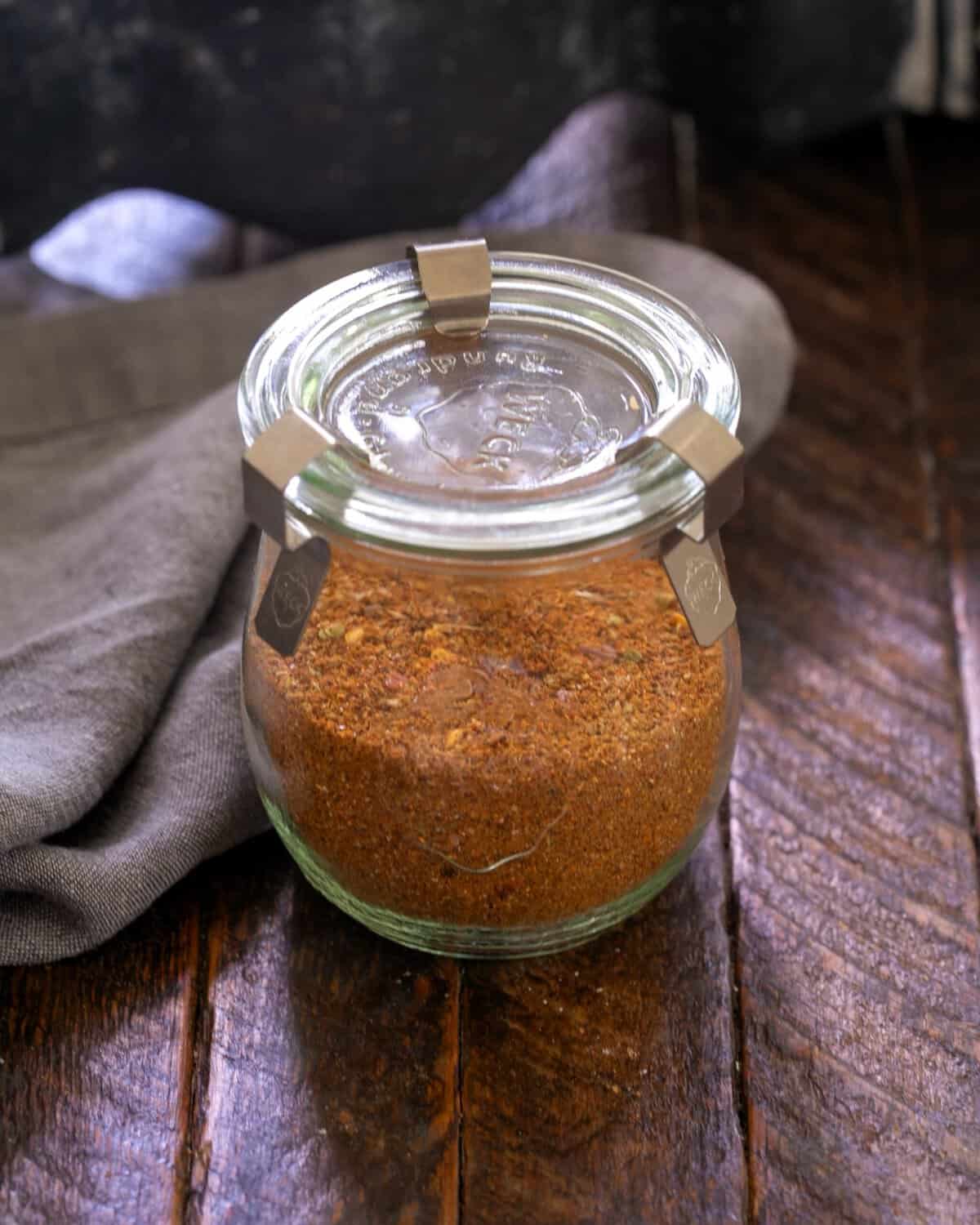 Taco seasoning in a glass storage container.