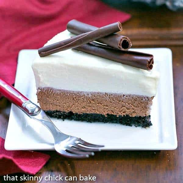 A Slice of chocolate mousse cake on a white plate