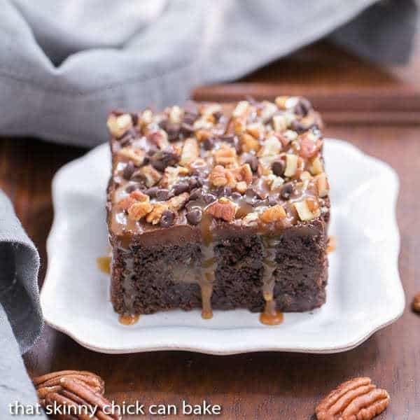 A piece of turtle poke cake on a square white plate