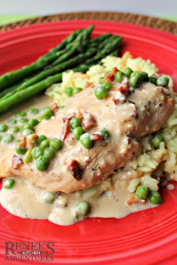 Chicken with Pancetta Cream and Peas on a red dinner plate