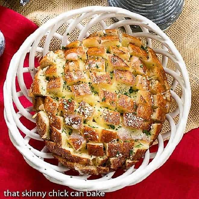 Overhead view of Cheesy Garlic Bread in a ceramic basket.