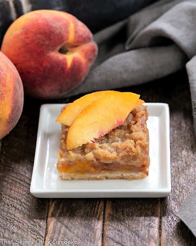 Fresh Peach Pie Bar on a white plate topped with peach slices