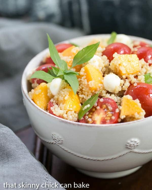 Peach Quinoa Caprese Salad in a white bowl